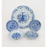 A CHINESE BLUE AND WHITE DISH painted with precious objects, within a foliate band, 27.5cm diameter,