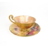 A ROYAL WORCESTER FRUIT PAINTED TEA CUP AND SAUCER the cup with apples and grapes, the saucer with
