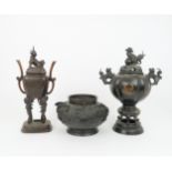 A CHINESE BRONZE AND ENAMEL INCENSE BURNER cast with shishi and decorated with taotie masks, 37cm