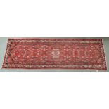 A RED GROUND IRANIAN HAMEDAN RUNNER with all over design and multiple borders, 339cm long x 108cm