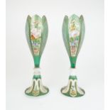 A PAIR OF BOHEMIAN GREEN GLASS VASES of tulip form with alternating cameo panels of painted