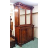 A VICTORIAN MAHOGANY TWO DOOR BOOKCASE ON CABINET BASE