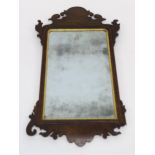 A GEORGIAN MAHOGANY AND GILTWOOD WALL MIRROR 90cm high x 49cm wide Condition Report:Available upon