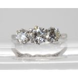 A THREE STONE DIAMOND RING set throughout in platinum. the three brilliant cut diamond are estimated
