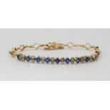 A VINTAGE SAPPHIRE AND DIAMOND BRACELET mounted throughout in yellow and white metal, set with