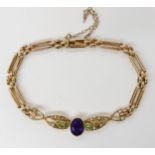 A 15CT GOLD EDWARDIAN BRACELET in the suffragette colours. Set with demantoid garnet, (green,)