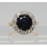 AN 18CT GOLD SAPPHIRE AND DIAMOND RING sapphire approx 9.1mm, surrounded with estimated approx 0.