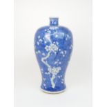 A CHINESE BLUE AND WHITE BALUSTER VASE painted with blossoming branches on an ice-cracked ground,