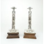 A PAIR OF CHINESE SILVER CANDLESTICK LAMPS cast with sinuous dragons, beneath acanthus leaf and