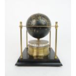 A ROYAL GEOGRAPHICAL SOCIETY WORLD CLOCK with rotating terrestrial globe and gilt metal chassis,