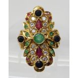 A BRIGHT YELLOW METAL GEM SET RING stamped 750 to the inner shank, set with rubies, sapphires,