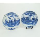 TWO CHINESE BLUE AND WHITE DISHES painted in a similar manner to the previous lot, 26.5cm diameter