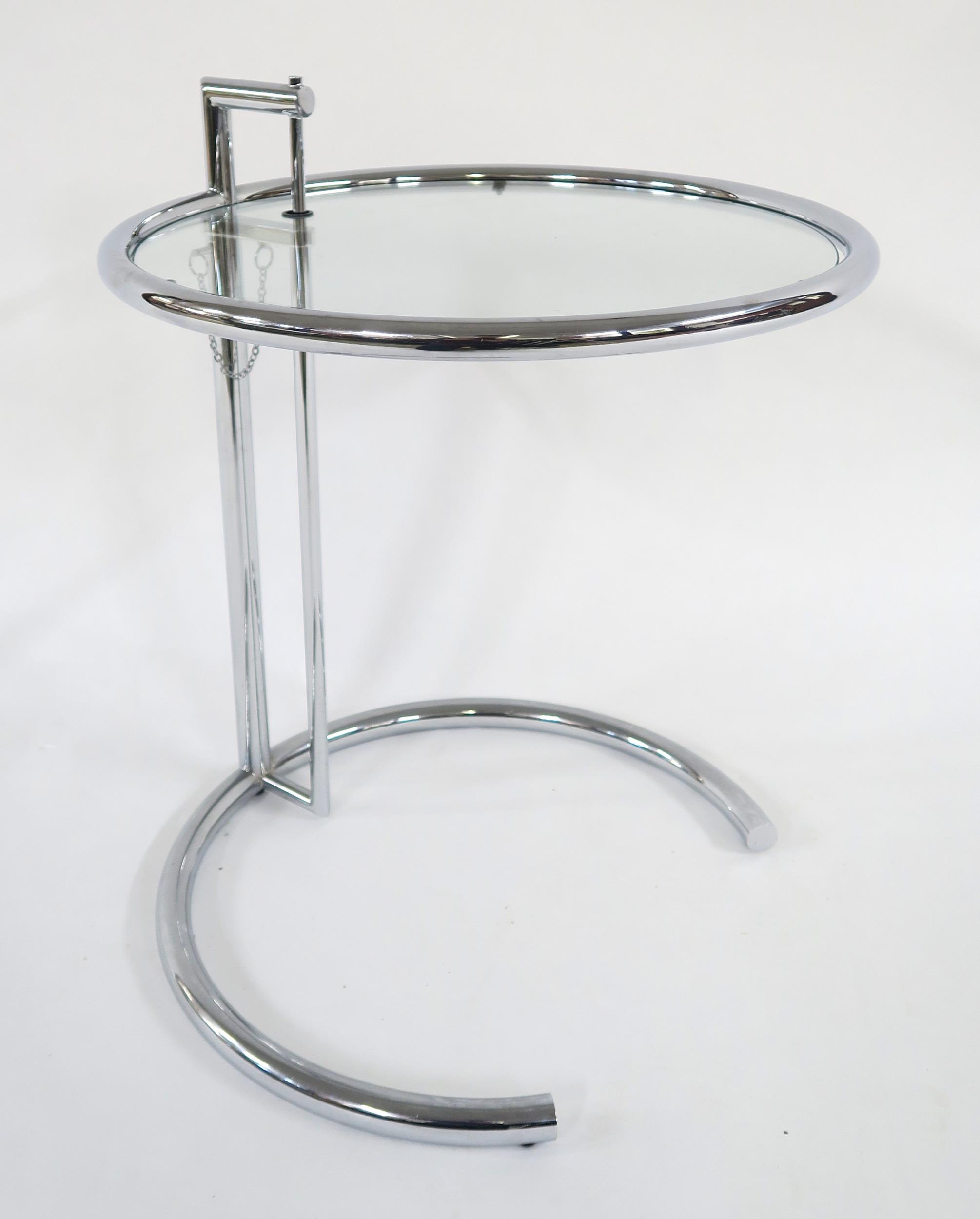 A MID 20TH CENTURY AFTER EILEEN GRAY E-1027 ADJUSTABLE TABLE with circular glass table top on