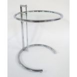 A MID 20TH CENTURY AFTER EILEEN GRAY E-1027 ADJUSTABLE TABLE with circular glass table top on