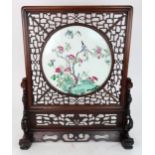 A CHINESE FAMILLE ROSE TILE TABLE SCREEN painted with a bird amongst flowering branches and above