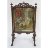 A VICTORIAN MAHOGANY AND ROSEWOOD FRAMED TAPESTRY FIRESCREEN with top rail carved in the form of two