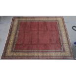 A RED GROUND ARAAK RUG with multicoloured geometric borders 370cm long x 283cm wide Condition