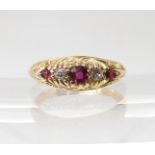 AN 18CT GOLD RUBY AND DIAMOND RING in a traditional scroll mount, finger size L, weight 4.5gms