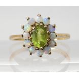 A 9CT GOLD PERIDOT AND OPAL CLUSTER RING the central peridot is approx 6.7mm x 5.3mm, surrounded