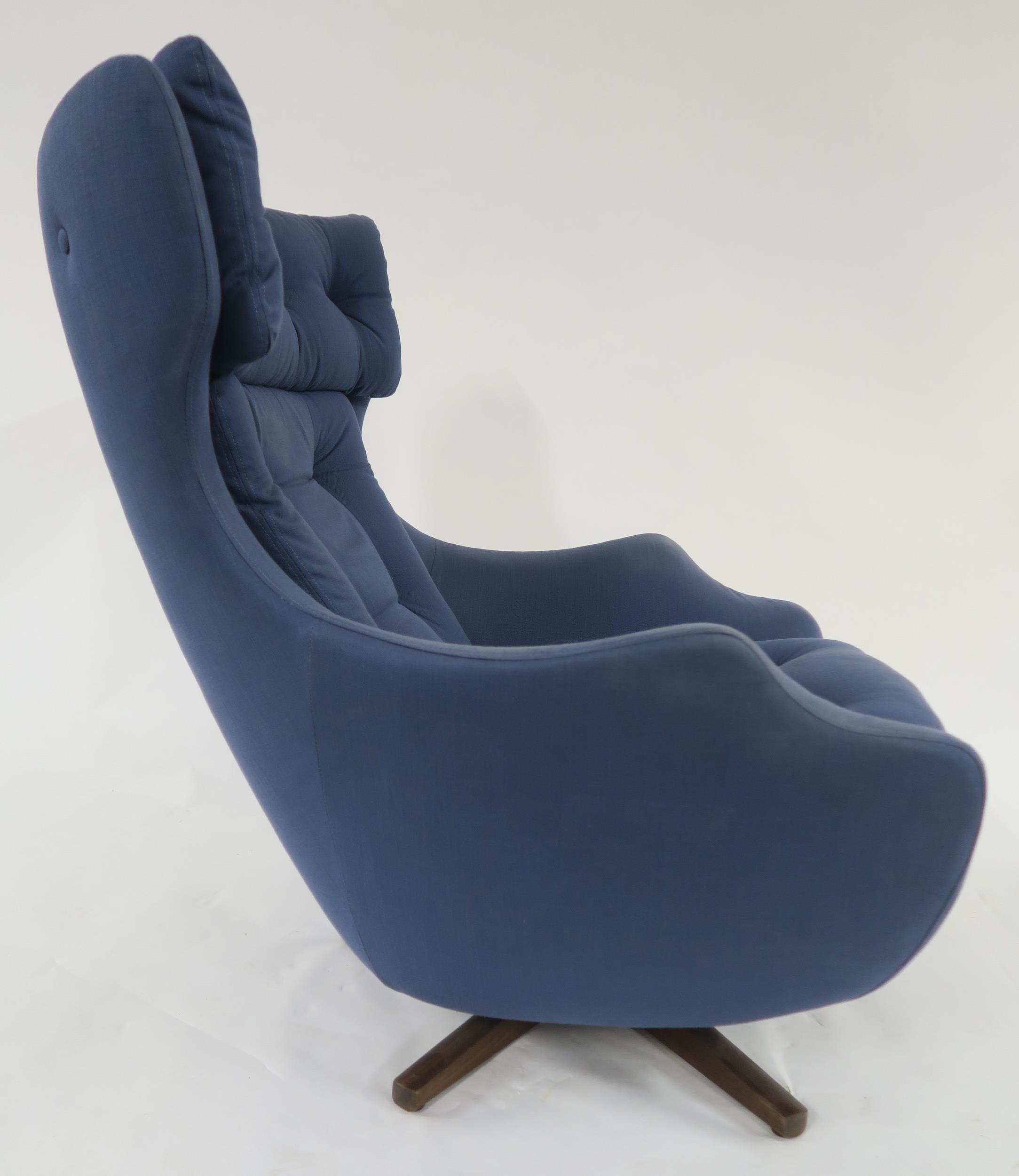 A MID 20TH CENTURY PARKER KNOLL "STATESMAN" SWIVEL ARMCHAIR with blue buttoned upholstery on stained - Image 4 of 8
