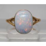 A 9CT GOLD OPAL RING set with a lively white opal of approx 12.2mm x 9.3mm. Finger size P1/2, weight