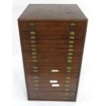 A LATE VICTORIAN STAINED PINE TWENTY DRAWER SPECIMEN CHEST with brass campaign style drawer pulls,
