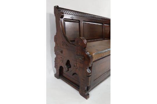 A LATE VICTORIAN OAK GOTHIC STYLE SETTLE with panelled back above Rexine upholstered seat with - Image 3 of 7