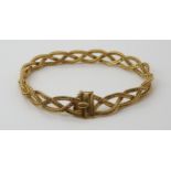 AN 18CT GOLD ITALIAN MADE PLAITED BRACELET made from three strands of herringbone chain, with