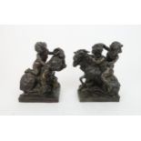 A PAIR OF BRONZE GROUPS modelled as putti and goats beside baskets of grapes, 21cm high Condition