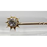 A BOXED DIAMOND TOPPED SUNBURST PIN that also converts to a shirt stud, set with an estimated approx