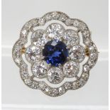 A SAPPHIRE AND DIAMOND BROOCH set with a mid blue sapphire approx diameter 6.1mm, surrounded with