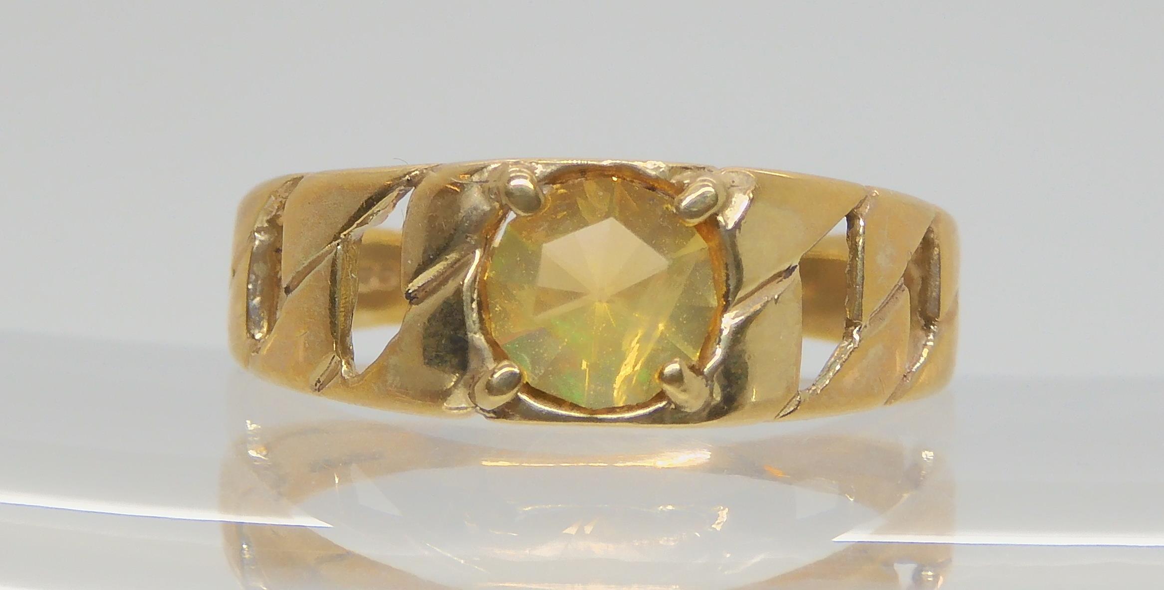 A 9ct gold chain pattern ring, set with a fire opal, size U, weight 3.2gms Condition Report:
