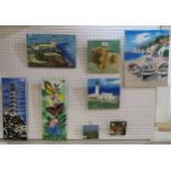 A collection of tubelined Skye tiles including a lighthouses, highland cattle coastal views etc