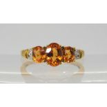 A 9ct gold orange gemstone and diamond ring, size O1/2, weight 2.6gms Condition Report:Available