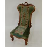 A Victorian walnut framed Prie Dieu chair with floral tapestry upholstery on cabriole supports