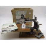 An "Essex Miniature Sewing Machine", hand-crank operated, with its original instructions and