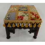 An eastern footstool in the manner of Liberty & Co "Cairo" stool with tapestry upholstery
