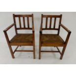 A pair of 20th century rushed seat open armchairs (2) Condition Report:Available upon request