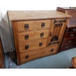 An early 20th century oak Arts and Crafts chest of drawers with three short drawers beside single