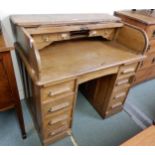 A 20th century oak tambour top twin pedestal writing desk Condition Report:Available upon request