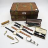 A brass-bound burr walnut stationary box, containing an assortment of wristwatches (inc.