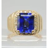 A 9ct gold gents ring set with a vermeil lab created sapphire and diamond accents, size Y1/2, weight