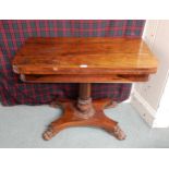 A Victorian rosewood fold over games table on quadrupedal base with paw feet Condition Report: