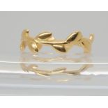 An 18ct gold Tiffany Olive leaf band ring, designed by Paloma Picasso, size N1/2, weight 2.5gms.