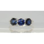 A bright white metal three sapphire ring, size K1/2, weight 2.8gms Condition Report:Very light