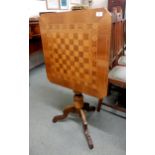 A Victorian walnut and sample wood inlaid tilt top games table on turned tripod base Condition