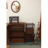 A 20th century hardwood open bookcase, mahogany commode, brass standard lamp, oval wall mirror,