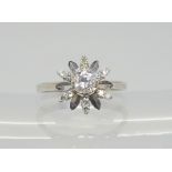 An 18ct white gold diamond snowflake ring, the main diamond is estimated approx at 0.30cts, finger