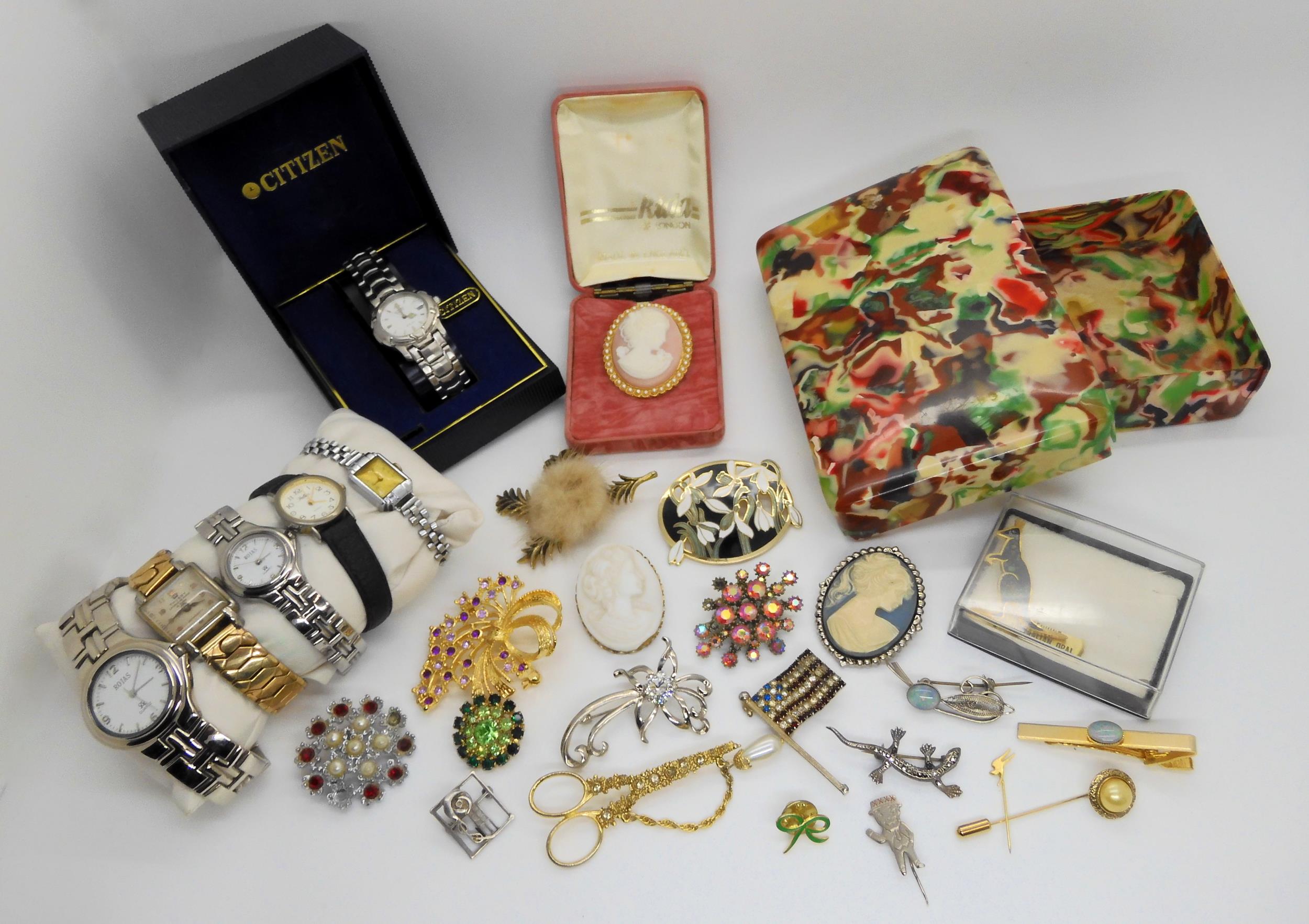 An early plastic box filled with vintage costume jewellery and watches Condition Report:Not