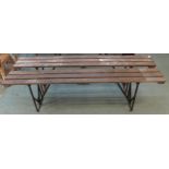 A pair of 20th century wooden benches with iron folding supports, 50cm high x 181cm long x 24cm deep
